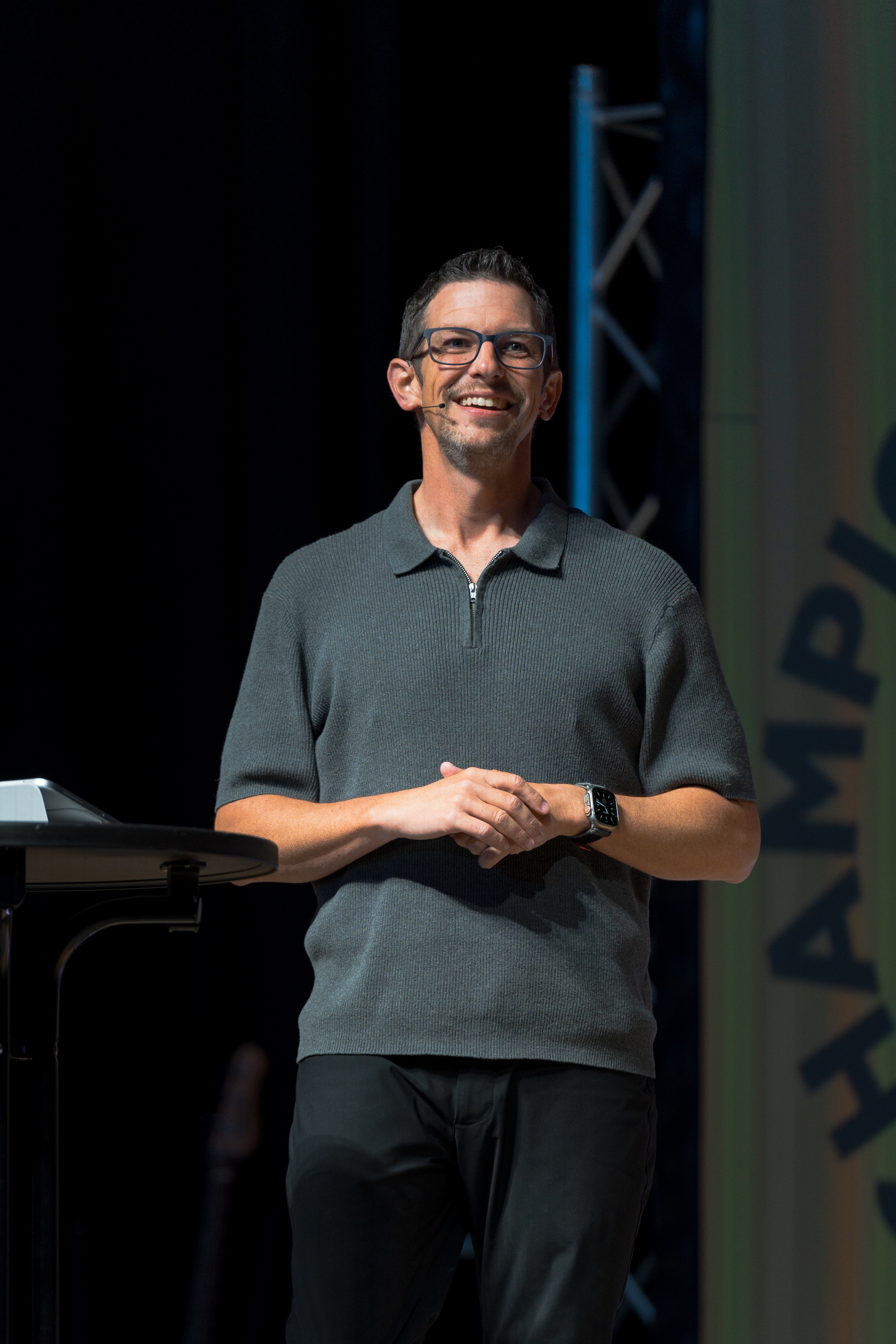 Jeremy Godwin smiling while speaking on stage.